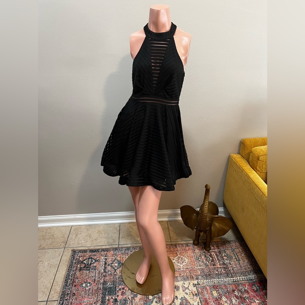 LUXXEL little black dress! Contemporary lines and fluttering skirt! Open back!